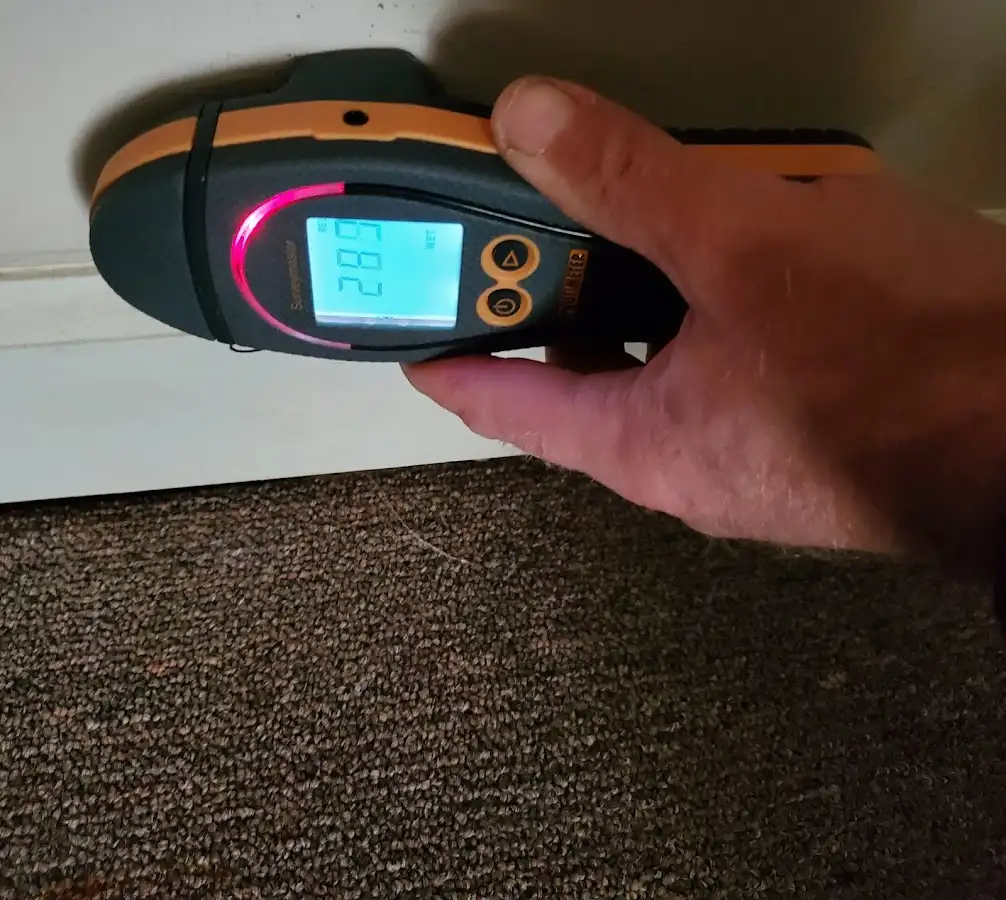 Moisture detection at baseboard during Storm Damage Restoration in Valley
